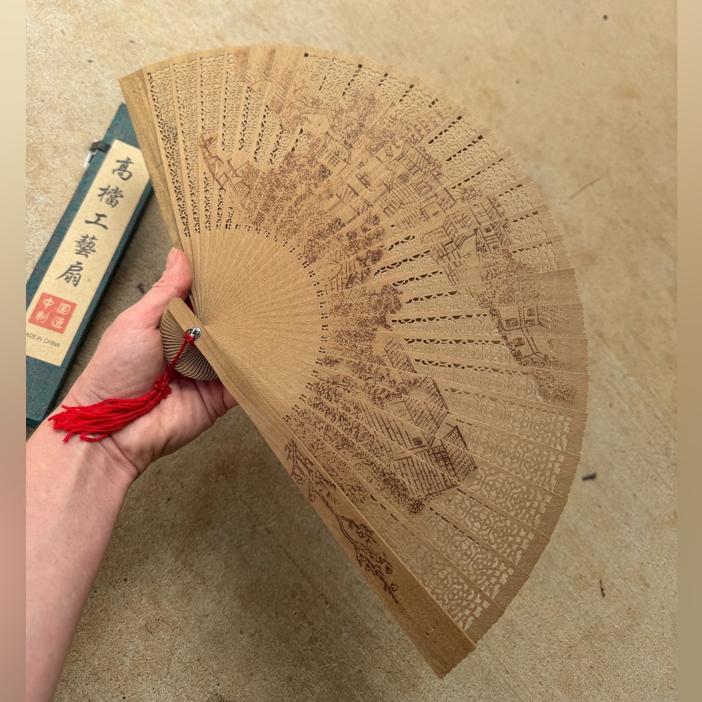 Intricate Brown Hand Fan with Red Tassel